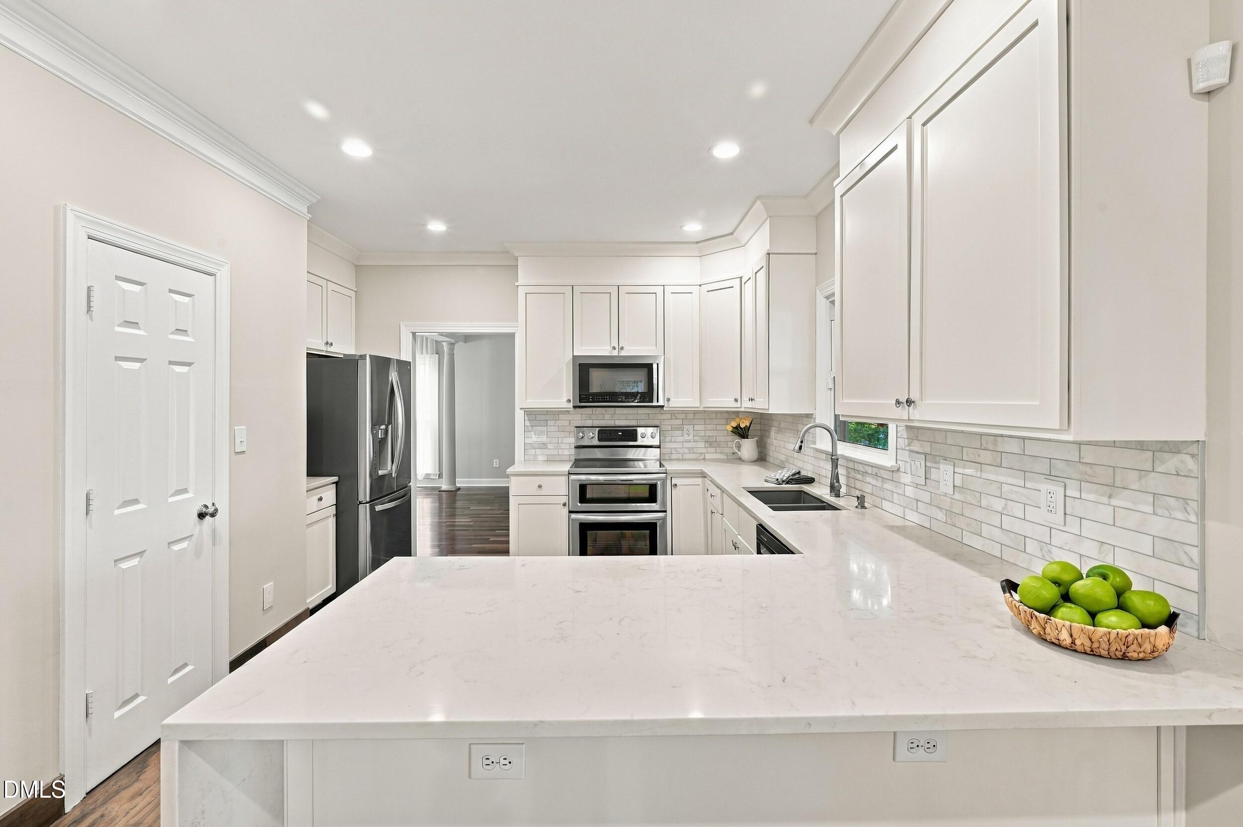 8505 Bluff Pointe Court Raleigh, NC 27615 - Photo 7 of 39 Bright and light kitchen done in 2017.