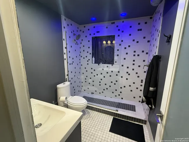 a bathroom with a toilet and a shower curtain