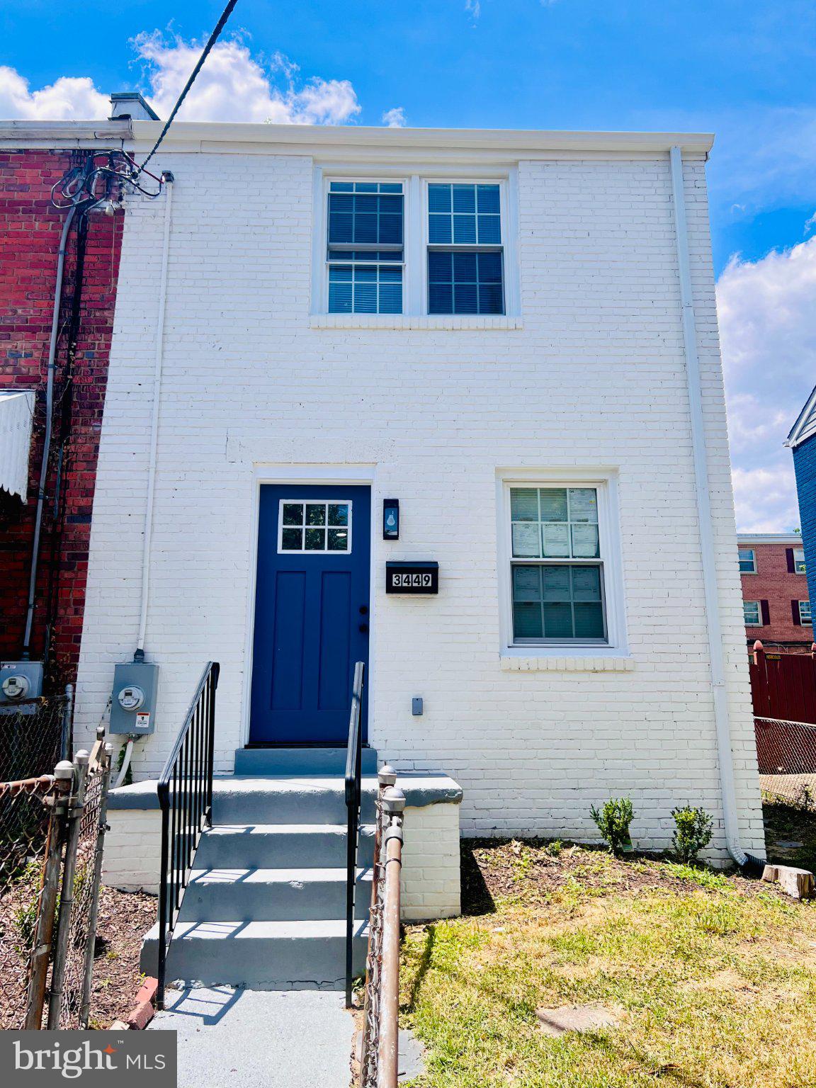 3449 23rd Street Southeast Washington, DC 20020 - Photo 1 of 8 Charming white brick home with blue door.