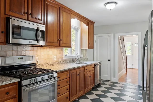 a kitchen with stainless steel appliances a stove a sink and a microwave