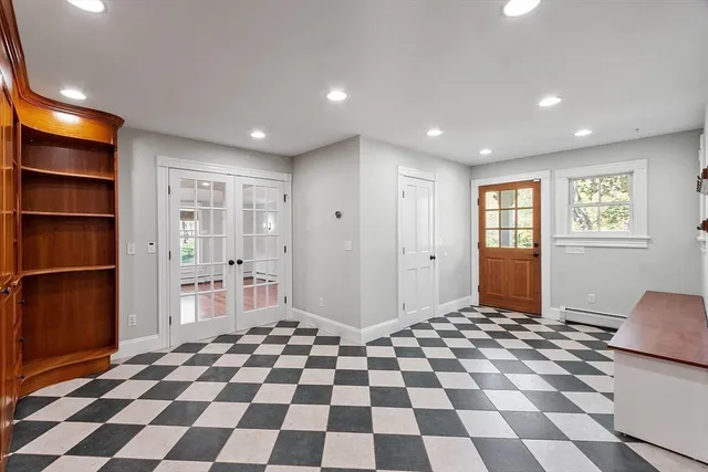 a view of a big room with a fireplace and a chandelier