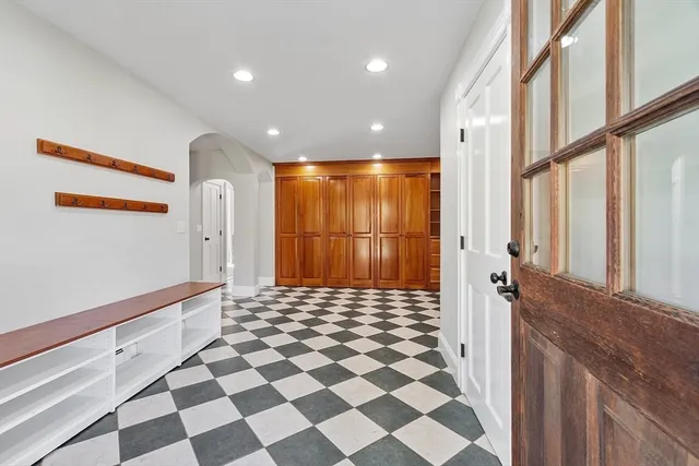 a bathroom with a black and white checkered floor