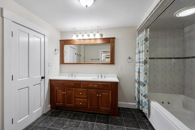 a bath room with a sink and a large mirror