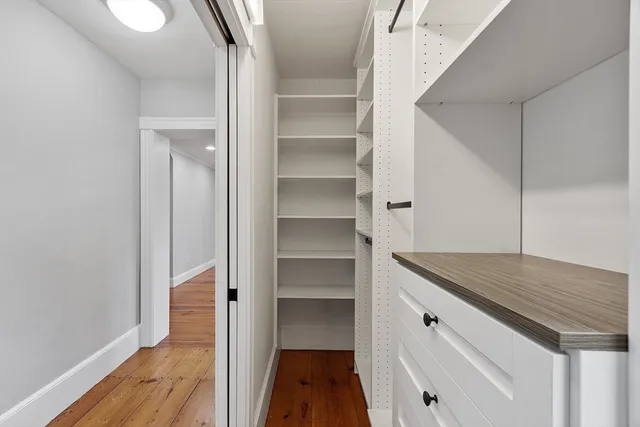 a hallway view with wooden floor