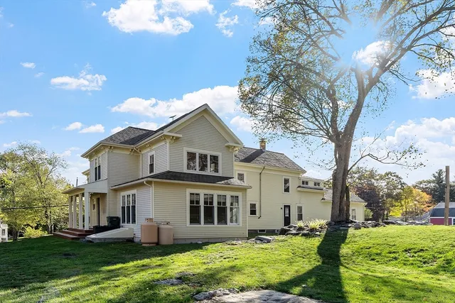 a front view of house with yard and trees around