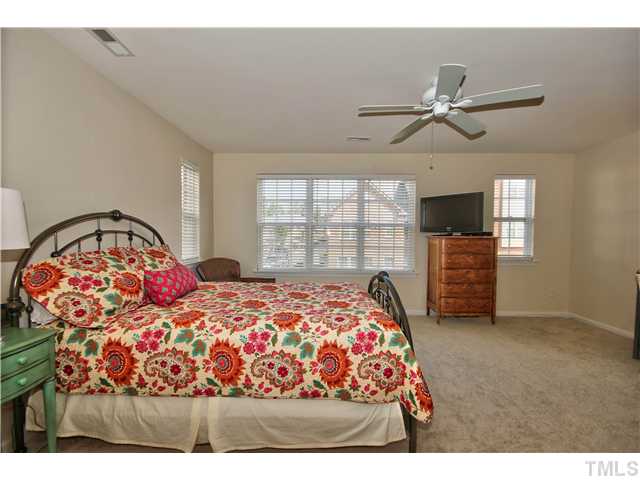 9827 Layla Avenue Raleigh, NC 27617 - Photo 14 of 20 a bedroom with a large bed and a window