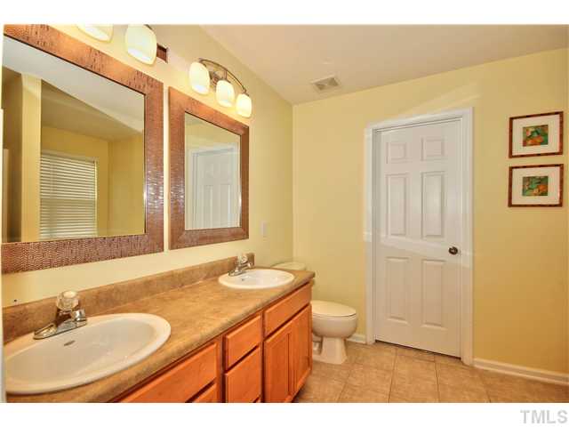 9827 Layla Avenue Raleigh, NC 27617 - Photo 15 of 20 a bathroom with a granite countertop sink toilet and shower