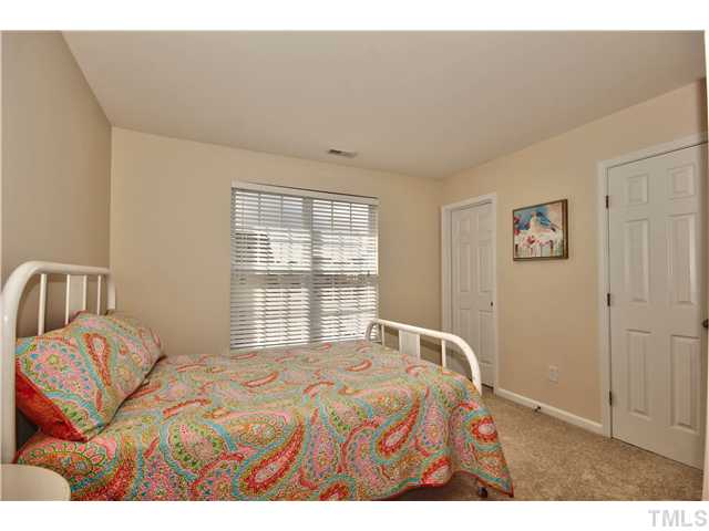 9827 Layla Avenue Raleigh, NC 27617 - Photo 17 of 20 a bedroom with a bed and a window