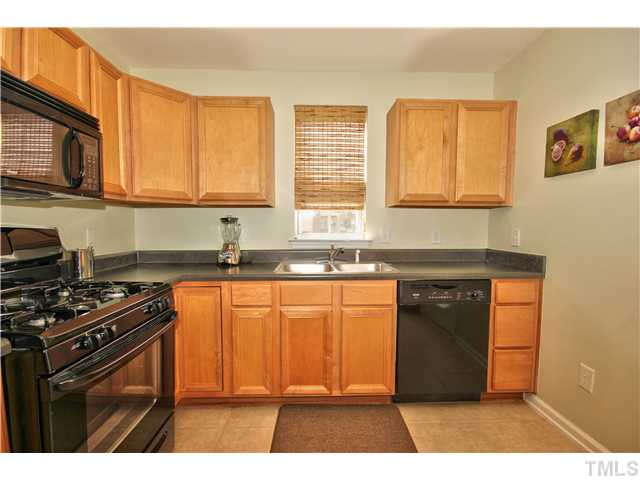 9827 Layla Avenue Raleigh, NC 27617 - Photo 6 of 20 a kitchen with stainless steel appliances granite countertop a stove a sink dishwasher and a microwave oven with cabinets