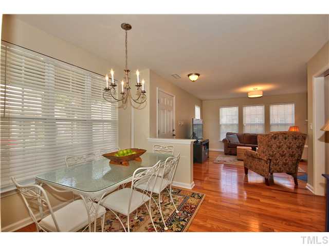 9827 Layla Avenue Raleigh, NC 27617 - Photo 10 of 20 a living room with furniture and a chandelier