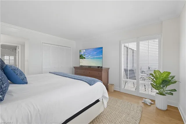 a bedroom with a bed and a flat screen tv in the kitchen