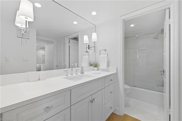 a bathroom with double sink and a mirror