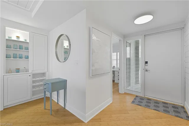 a view of a patio with a table and chairs and potted plants