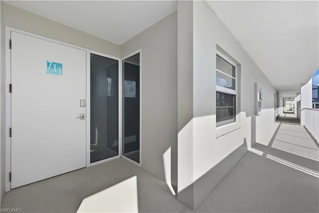 a view of kitchen with stainless steel appliances granite countertop a sink and a refrigerator