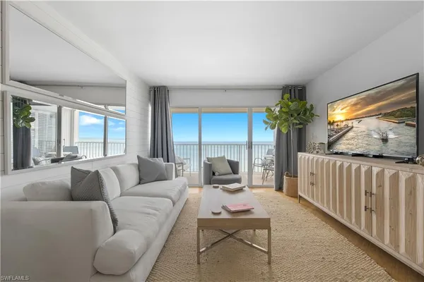 a living room with furniture and a large window