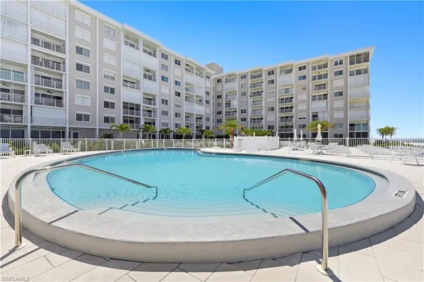 a swimming pool with outdoor seating