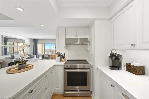 a kitchen with a sink a stove and cabinets