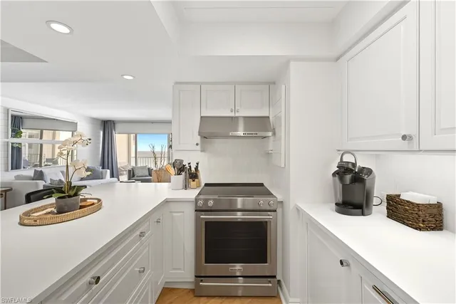 a kitchen with a sink a stove and cabinets