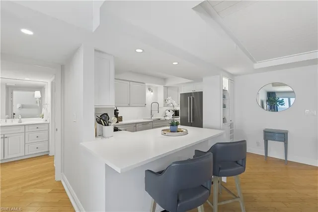 a living room with furniture a flat screen tv and a potted plant