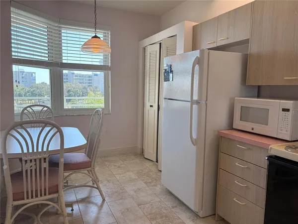 a kitchen with stainless steel appliances granite countertop a refrigerator and a stove