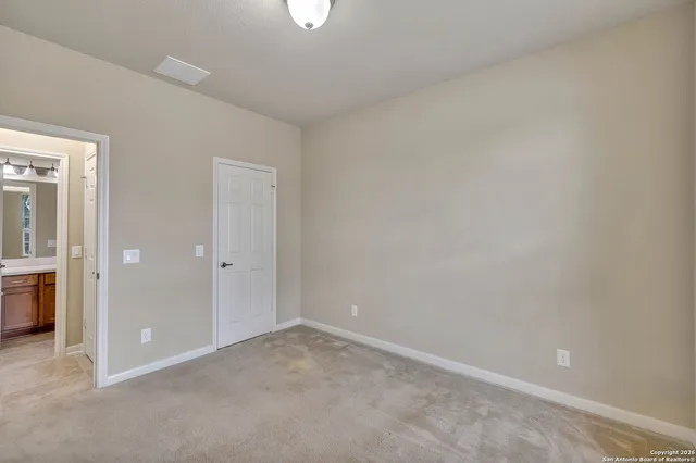 an empty room with a empty space and windows