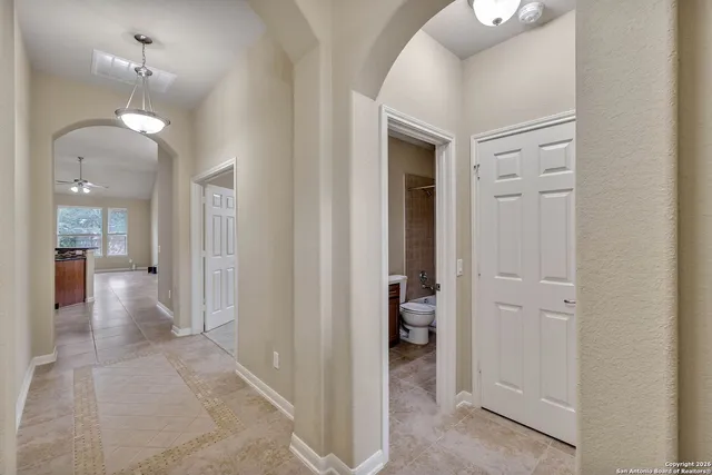 wooden floor with a chandelier in a room