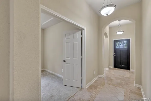 an empty room with window and bathroom