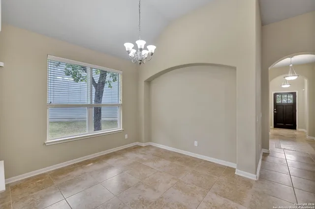 a view of an empty room with a chandelier
