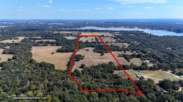 an aerial view of residential houses with outdoor space and seating