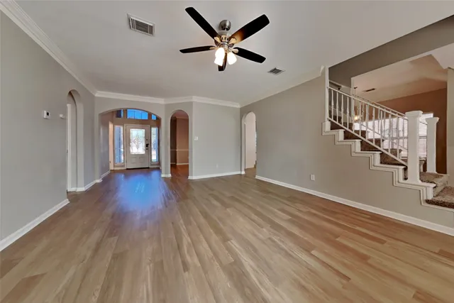a view of an empty room and wooden floor
