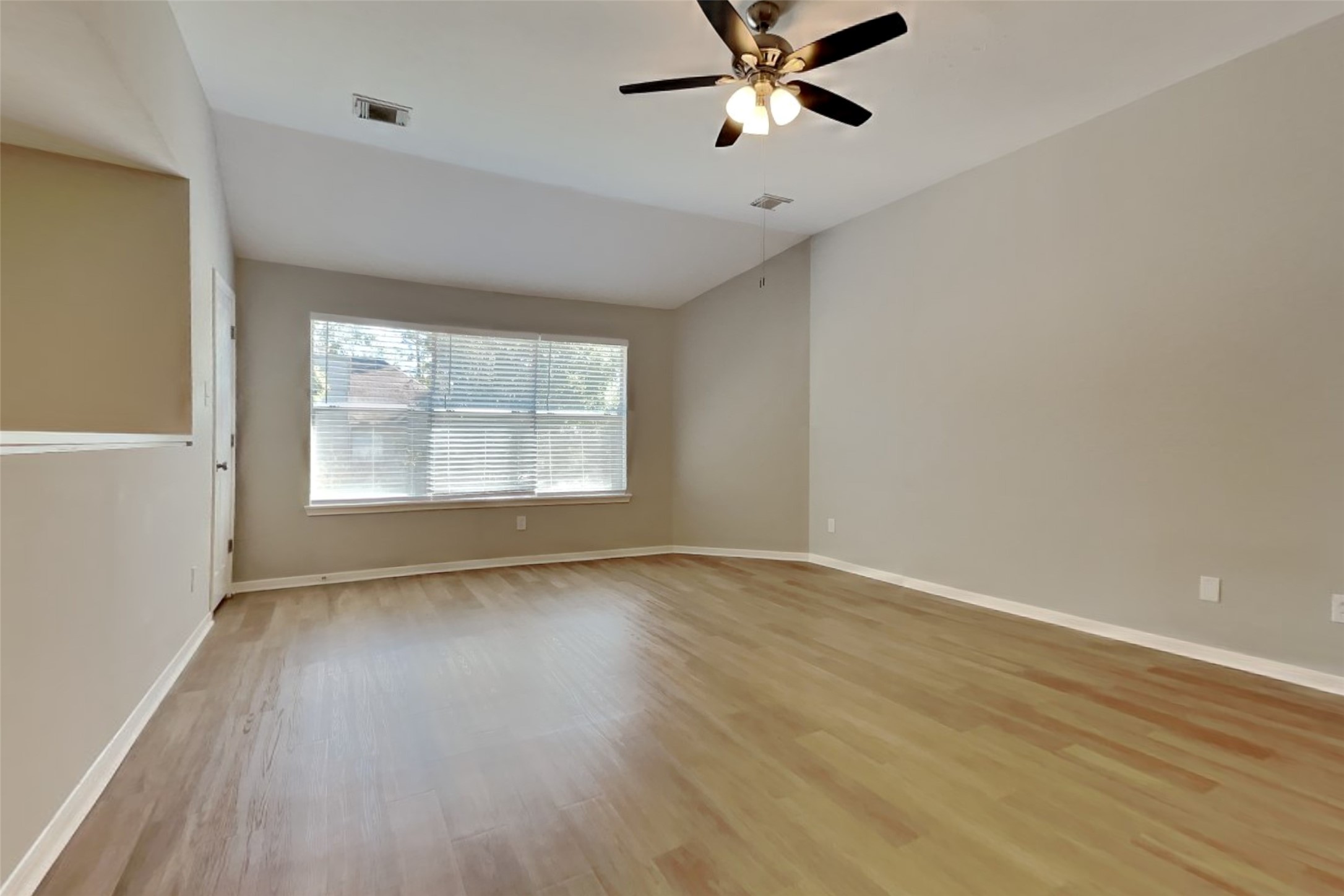 30110 Granum Drive Spring, TX 77386 - Photo 4 of 22 an empty room with wooden floor fan and windows