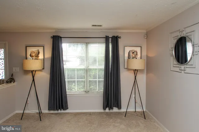 a livingroom with furniture a flat screen tv and a window