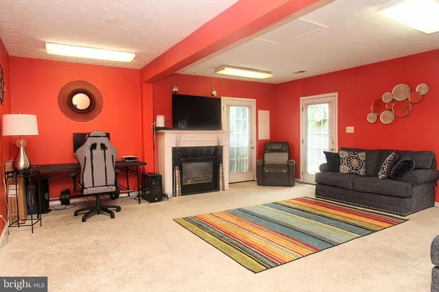 a living room with furniture flat screen tv and a fireplace