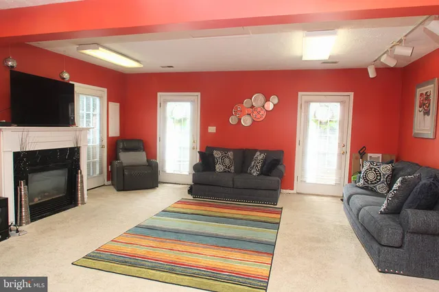 a living room with furniture a flat screen tv and a fireplace