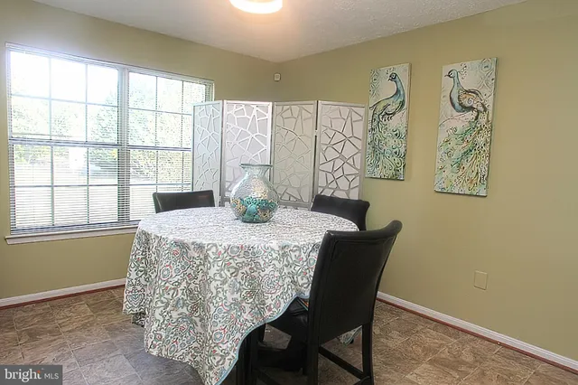 a dining room with furniture and window