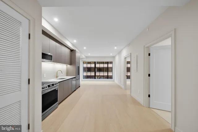 a view of a kitchen with a sink and a refrigerator