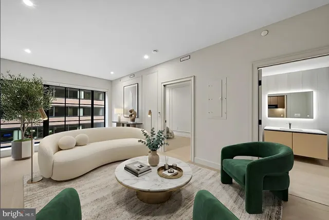 a living room with furniture and a potted plant