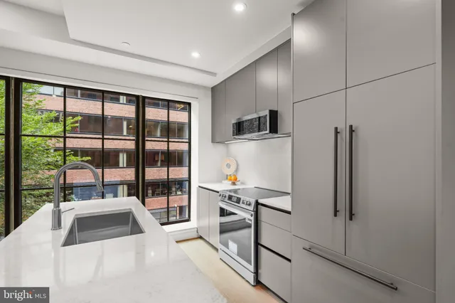a kitchen with stainless steel appliances a refrigerator and a sink