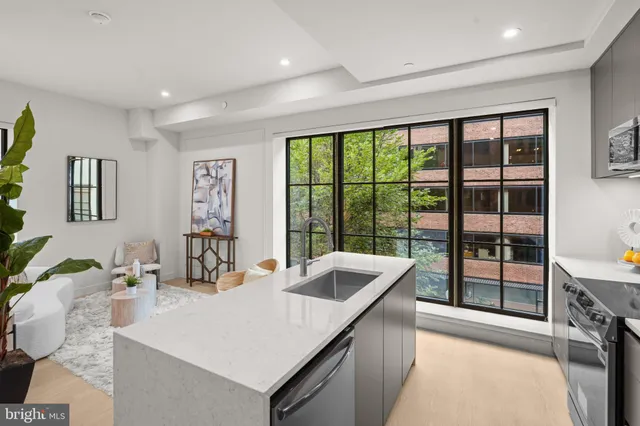 a kitchen with a sink and large window