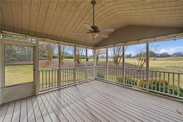 an aerial view of a house with swimming pool and outdoor seating