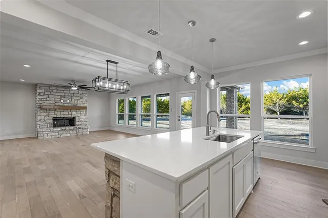 a large white kitchen with a large window