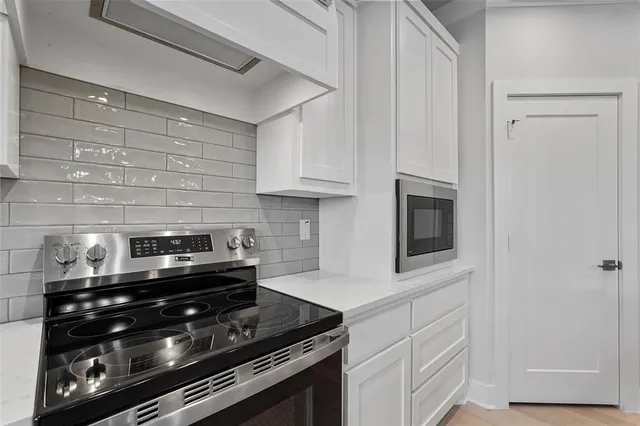 a kitchen with stainless steel appliances and cabinets