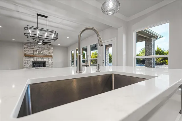 a view of spacious kitchen with granite countertop a large window and stainless steel appliances
