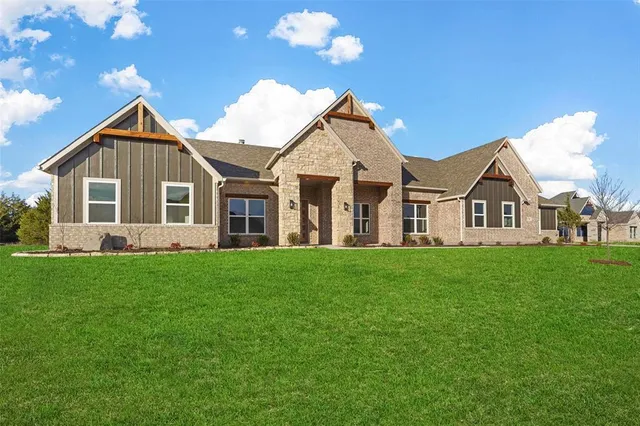 a view of a house with a big yard and garden