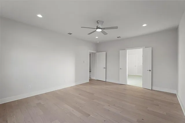 an empty room with fan and a ceiling fan