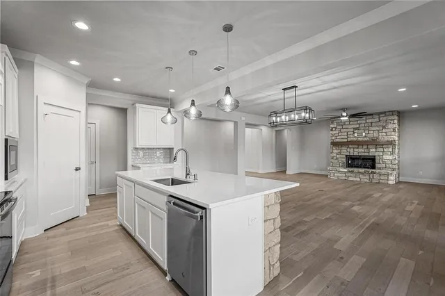 a kitchen with kitchen island a sink stove and refrigerator