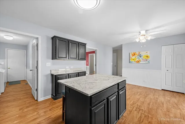 a kitchen with a stove and a wooden floor