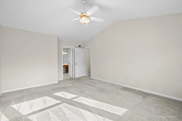 a view of an empty room with a ceiling fan
