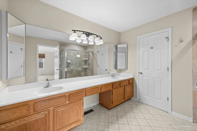 a large bathroom with a double vanity sink and a mirror