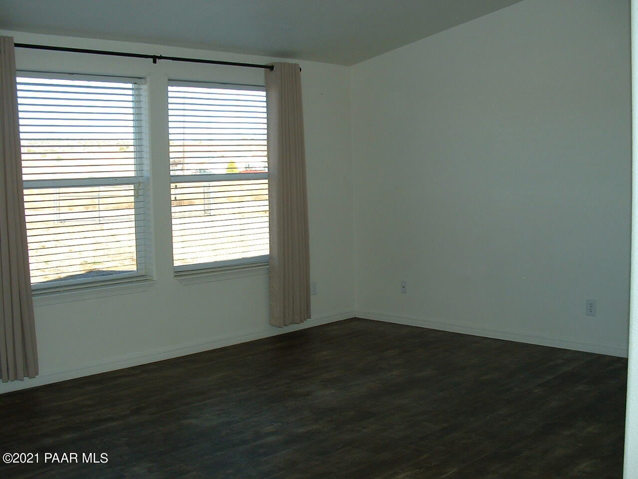 25 West Antelope Run Road Paulden, AZ 86334 - Photo 8 of 27 a view of an empty room with wooden floor and a window